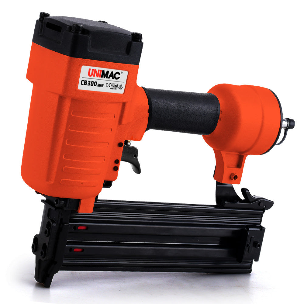 An orange and black air nail gun branded "UNIMAC Air Compressor Powered Nail Gun Concrete T-Nailer Pneumatic Heavy-Duty" model CB300 is shown against a white background. This heavy-duty nailer features a cylindrical body, a rubberized grip handle, and a black magazine at the base for holding nails.