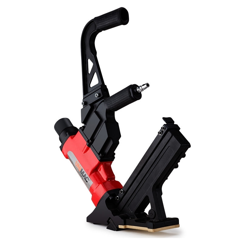 A red and black UNIMAC Pneumatic Flooring Nailer Staple Gun Floor Gas Nail Cleat Stapler with a black handle featuring a cushioned grip. The sleek pneumatic nailer has a magazine for nails attached at an angle and is perfect for hardwood flooring. The base is equipped with a footplate for stability during use.
