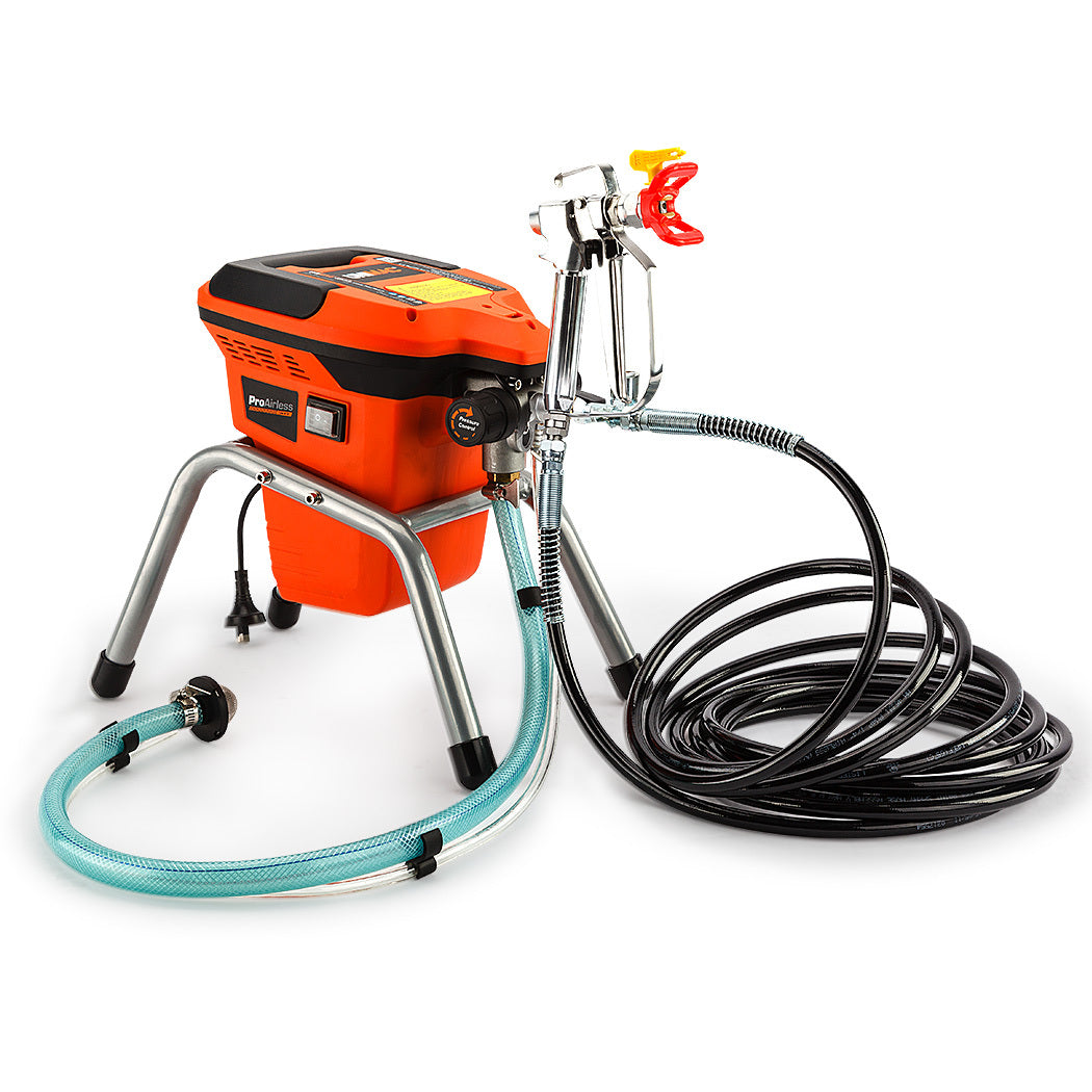 The Unimac 740W Electric Airless Paint Sprayer Portable High Pressure Station Spray Gun, featuring an orange and black main unit on metal legs, is ideal for paint renovating projects. It boasts a 740W airless system attached to a hose and spray gun, with another coiled hose, all set against a white background.