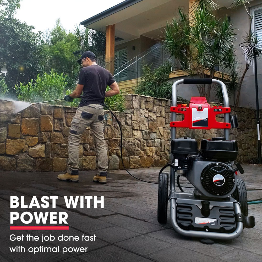 The JET-USA 4800PSI Petrol Powered High Pressure Washer, - CX630 features a black engine, large wheels, and a red control panel. Built with high-quality components, it includes various attachments and has a hose wrapped around the top. The metal frame with handlebars ensures easy maneuverability.