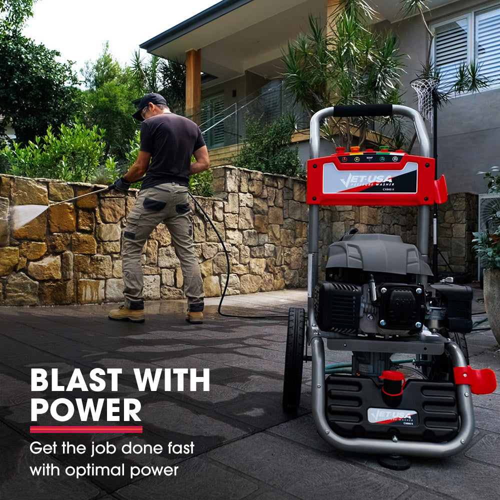 A black and red JET-USA 7HP 4800PSI Petrol High Pressure Washer Cleaner, Water Spray Gunrey, 30m Hose Drain Cleaner with large wheels is shown in a frontal view. It features a hose, spray gun holder, visible engine, and control panel on top. The design includes a sturdy frame and ergonomic handle for easy maneuvering, promising high power output for demanding tasks.