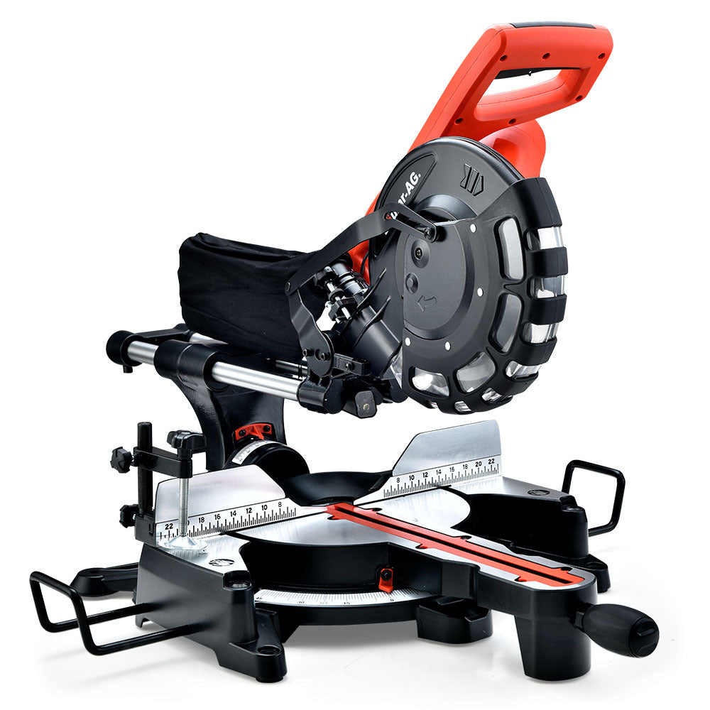 Image shows a black and red BAUMR-AG 254mm Dual Bevel Sliding Compound Mitre Drop Saw featuring a 2000W motor and a tungsten carbide tipped blade with a blade guard. The saw is positioned on a base with measurement guides and adjustment handles. The design includes an ergonomic handle, adjustable angles, and a dust collection bag.