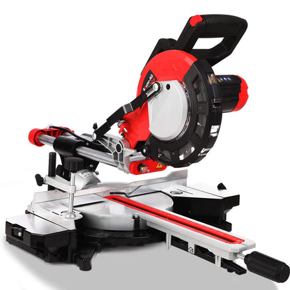 A red and black Baumr-AG Sliding Compound Mitre Saw Electric Bench Drop Chop Single Bevel Table is depicted, featuring a tungsten carbide tipped blade mounted on a swiveling arm. It's attached to a base with measuring guides and powered by a robust 2000W motor. Various adjustment knobs and clamping mechanisms are present for precise cutting angles and stability.