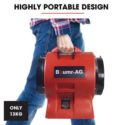 A red Tradie's Mate Baumr-AG 300mm (12 inch) Portable Axial Air Mover Blower Fan with a cylindrical shape and a black front-facing guard. Behind it, an orange and black accordion-style ventilation duct extends outward. This industrial blower fan ensures powerful airflow for effective air circulation, proudly labeled "Baumr-AG" on its side.