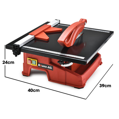 A red and black BAUMR-AG 600W Electric Tile Saw Cutter with 180mm (7") Blade features a wet-cutting system with a powerful 600W motor. The circular blade is partially covered by a protective guard, and the machine sports the "Baumr-AG" logo on the front. It also includes a measurement guide on the top surface for precise cutting.