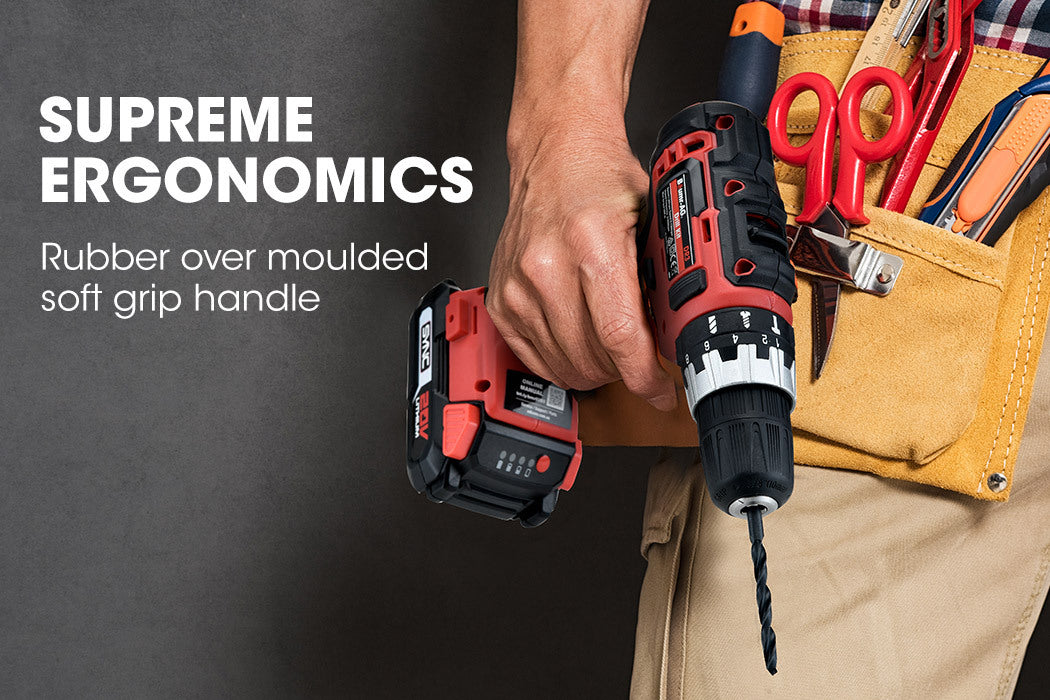 A red and black cordless drill labeled "BAUMR-AG 20V Cordless Power Drill Kit Lithium Battery Hammer Drilling with Bag" is shown from the side. The drill features TriMode technology, and an accompanying battery charger with a two-prong plug is placed beside it.