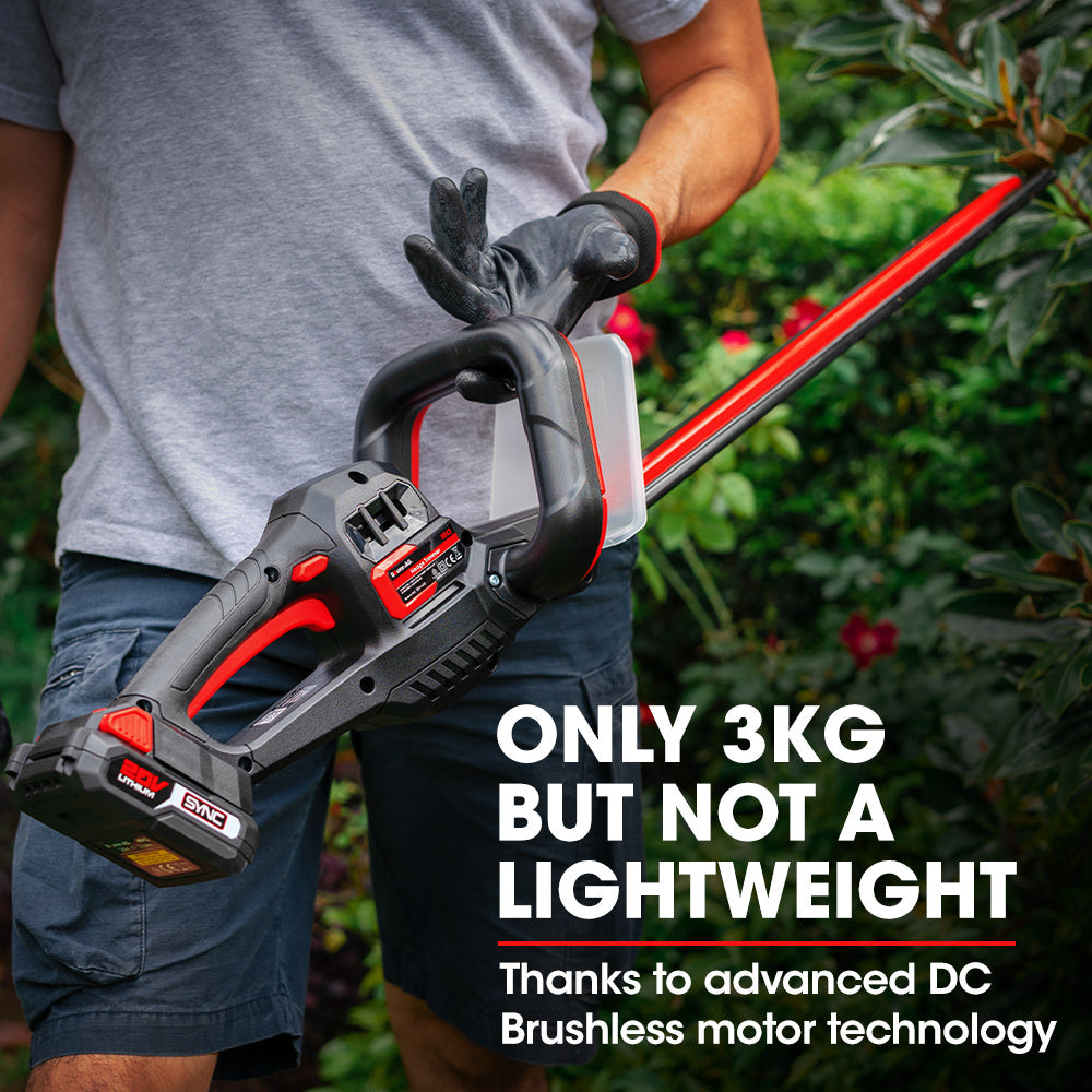 This red and black BAUMR-AG 20V Cordless Electric Hedge Trimmer Shrub Cutter with Rechargeable Battery & Charger Kit features TruSharp high-grade blades and a long cutting edge. Designed for the 20V SYNC range, it includes a handle on top, a transparent guard near the blade, and comes complete with a battery and charger.