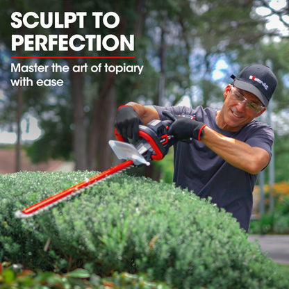 This red and black BAUMR-AG 20V Cordless Electric Hedge Trimmer Shrub Cutter with Rechargeable Battery & Charger Kit features TruSharp high-grade blades and a long cutting edge. Designed for the 20V SYNC range, it includes a handle on top, a transparent guard near the blade, and comes complete with a battery and charger.