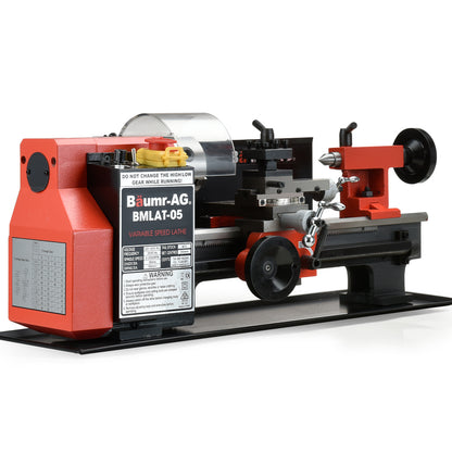 A red and black BAUMR-AG Mini Metal Lathe Small Hobby Micro Variable Speed Machine DIY Benchtop, featuring a control panel with warning labels, various knobs, a protective guard, and an operational bed. The lathe has a sturdy base and components for precision metalwork.