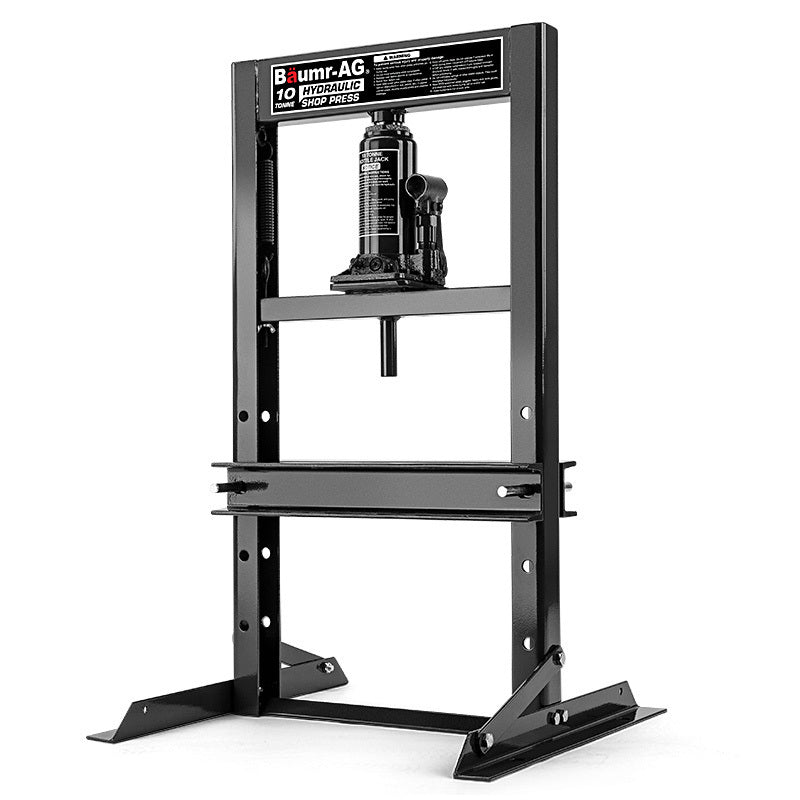 An industrial Baumr-AG 10 Tonne Hydraulic Shop Press Workshop Jack Bending Stand H-Frame made by Baumr-AG. Crafted from black steel, it features a bottle jack in the center, adjustable worktable heights, and sturdy base plates for stability—perfect for a range of mechanical pressing tasks.