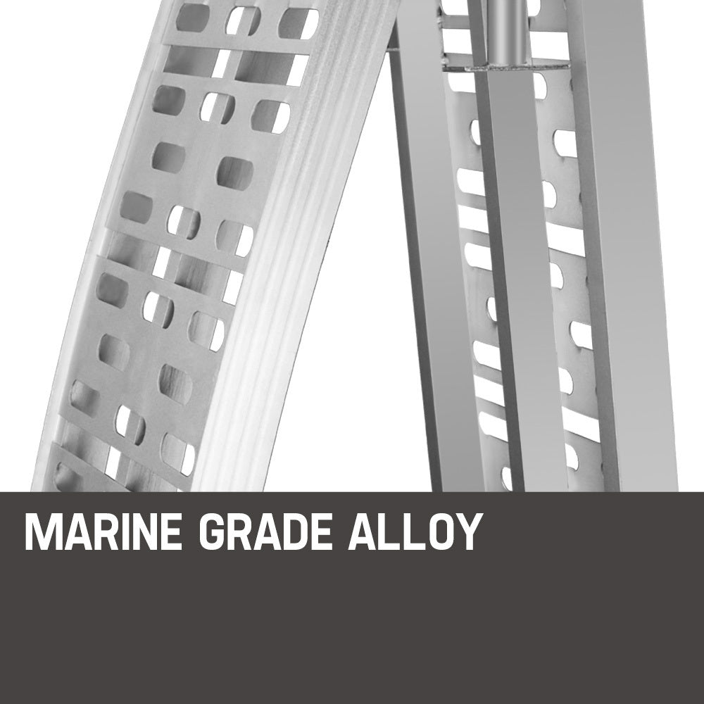 A pair of BULLET Pair of 2.3m Aluminium Loading Ramps, 1360kg capacity crafted from marine grade alloy, featuring perforated surfaces and red-tipped ends. With a 1360kg loading capacity, one ramp lies flat on the ground while the other leans against it in an open position for visibility.