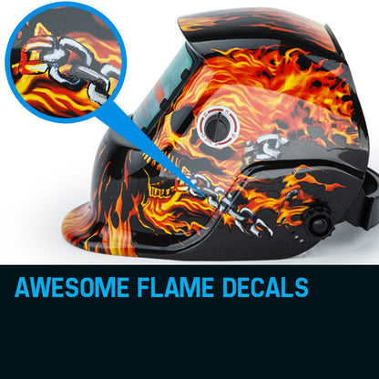 A black ROSSI Solar Auto Darkening Welding Helmet Mask MIG/ARC/TIG Welder Machine with an artistic design featuring vibrant flames and a fiery skull on the sides. This solar helmet boasts a wide viewing window with automatic tinting and an adjustable knob for optimal comfort.