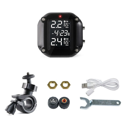 A close-up image of a digital display device from a RYNOMATE Tire Pressure Monitoring System (Motorcycle 2 Sensor) RNM-TPMS-101-LBD shows various measurements. The screen displays pressure readings in bar units: 2.2 for FW and 2.4 for RW, enhancing increased fuel efficiency. It also shows two temperature readings at 65°C and the current time, 4:23 PM. The device has a black frame.