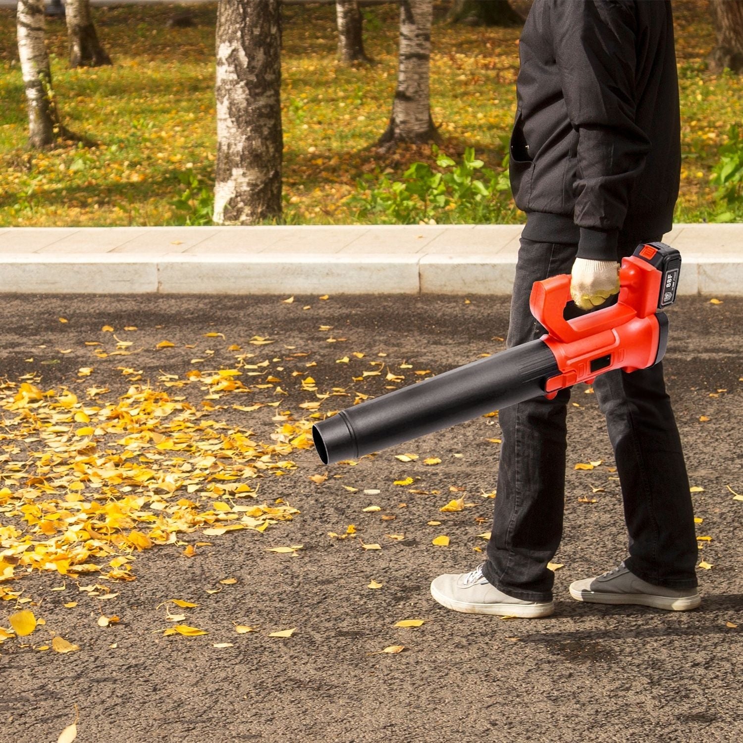 A red and black RYNOMATE 18V Cordless Leaf Blower with Lithium Battery and Charger Kit (Red and Black) RNM-LB-101-RTT is shown against a white background. The blower, featuring an ergonomic handle and an attached rechargeable lithium battery on top, boasts a 6-speed blowing capacity. One nozzle is flat and wide, while the other is round and tapered.