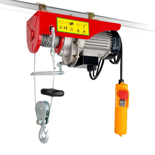 A red and silver Electric Hoist Remote Chain Lift 240V 510w 125/250KG is mounted on a metal rail. It features a steel cable wound around a spool, with a hook attached at the end. A yellow handheld remote control with a red emergency stop button is connected to the hoist by a black cable.