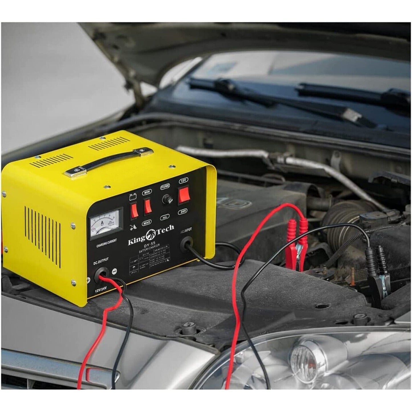 Image of a yellow and black Kingtech 2in1 Battery Charger Jump Starter New Dual Heavy Duty Car Charger 40Amp with red and black clamps attached. Labels indicate it works with 12V and 24V batteries. Featuring advanced pulse rectifier technology, it includes buttons and indicators for charging current, min/max settings, fuse, and battery selection.