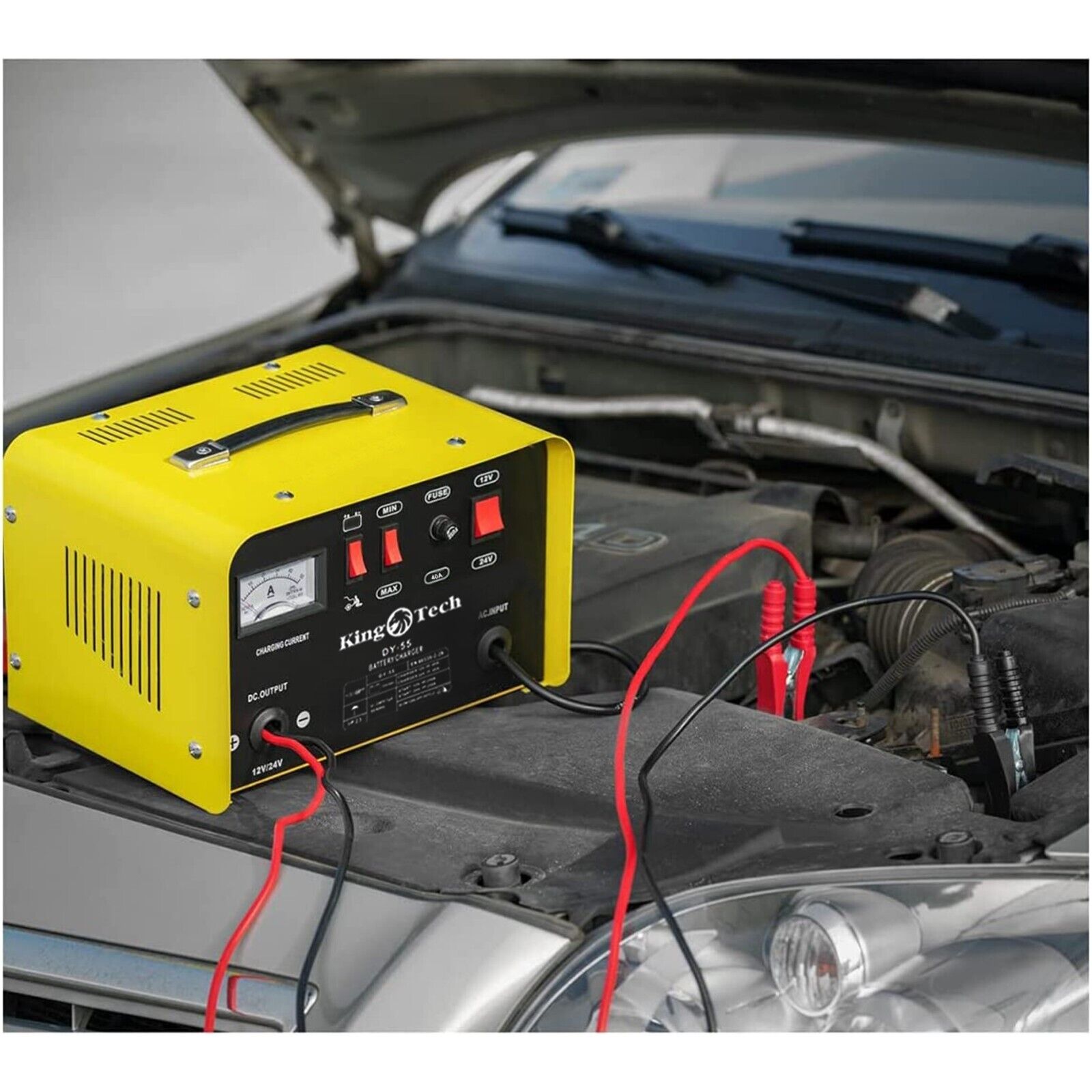 Image of a yellow and black Kingtech 2in1 Battery Charger Jump Starter New Dual Heavy Duty Car Charger 40Amp with red and black clamps attached. Labels indicate it works with 12V and 24V batteries. Featuring advanced pulse rectifier technology, it includes buttons and indicators for charging current, min/max settings, fuse, and battery selection.