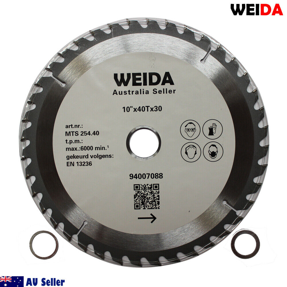 A circular saw blade labeled "3x 254mm Wood Circular Saw Blade Cutting 10’’40T Bore 30/25.4/22.23mm K 2.8mm." This tungsten carbide tipped cutting disc is 10 inches in diameter with 40 teeth. Other specifications include a 30mm arbor. Various certification icons and a QR code are visible on the blade. The image includes two washers placed beside the blade.