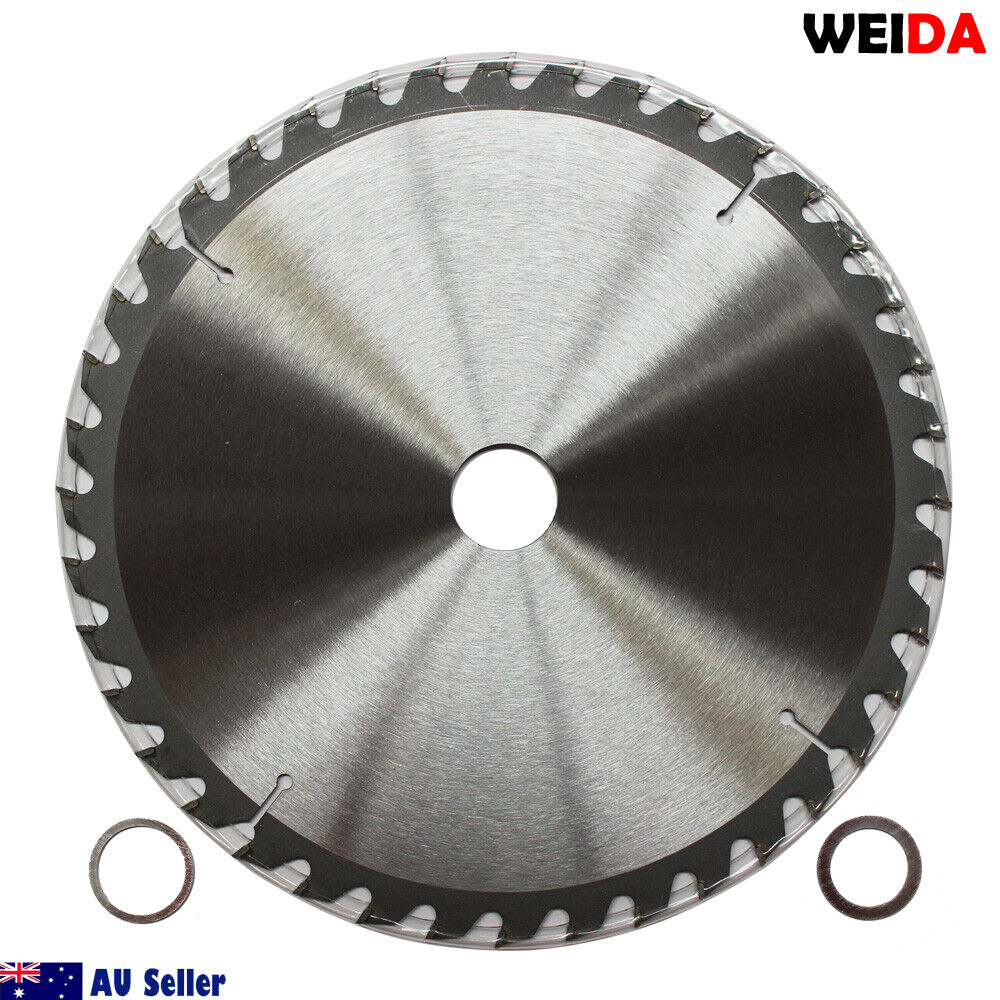 A circular saw blade labeled "3x 254mm Wood Circular Saw Blade Cutting 10’’40T Bore 30/25.4/22.23mm K 2.8mm." This tungsten carbide tipped cutting disc is 10 inches in diameter with 40 teeth. Other specifications include a 30mm arbor. Various certification icons and a QR code are visible on the blade. The image includes two washers placed beside the blade.