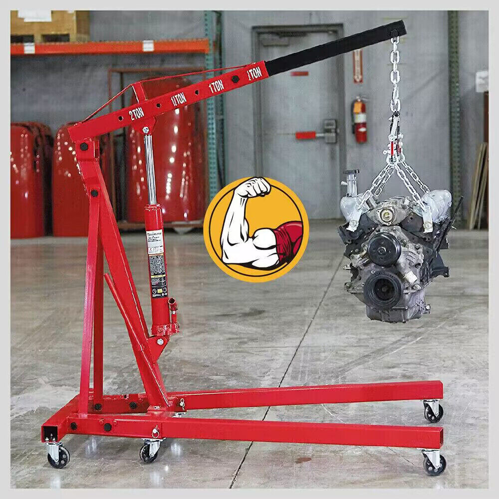 A 2-Ton Hydraulic Engine Crane Foldable Hoist Stand for Mobile Garage Lifting- Workshop Essential with a 2-ton weight capacity icon, featuring a foldable design and six wheels at the base for mobility. The hoist's arm is extended, set against a plain white background. Ideal for automotive and repair shops, this durable crane ensures efficient lifting and maneuverability.