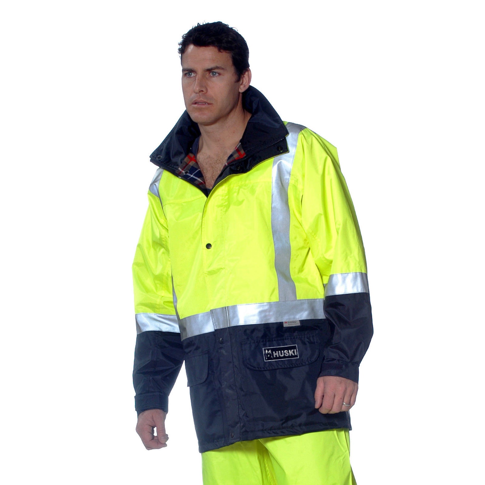 A high-visibility yellow and navy blue jacket with reflective silver stripes across the chest, sleeves, and waist. It features a front zipper, pockets with flaps, and a high collar. With its BREATHETEC coating, this waterproof HUSKI Transit Hi Vis Waterproof Jacket Industrial Workwear Reflective UPF 50+ - Yellow - 4XL (122cm) ensures safety and visibility in low-light conditions.