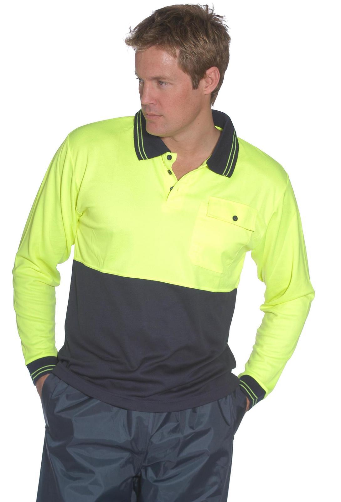 A man wearing a HUSKI Hi Vis Polo Shirt Long Sleeve Safety High Visibility Workwear Driver PPE - Yellow - XXL features a bright yellow upper section and a dark lower section. The shirt has a collar, chest pocket, and button details. His light brown hair complements his look as he stands with hands in his gray pants pockets.