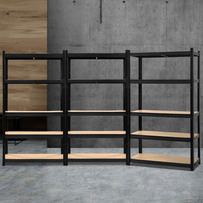 Three black **Giantz 3x1.8M Garage Shelving Warehouse Rack Pallet Racking Storage Shelf Black** units with multiple wooden shelves are arranged side by side, with the one on the right positioned at a slight angle. Each heavy-duty shelving unit has five adjustable beam shelves, offering ample storage space. The background is plain and unobstructed.